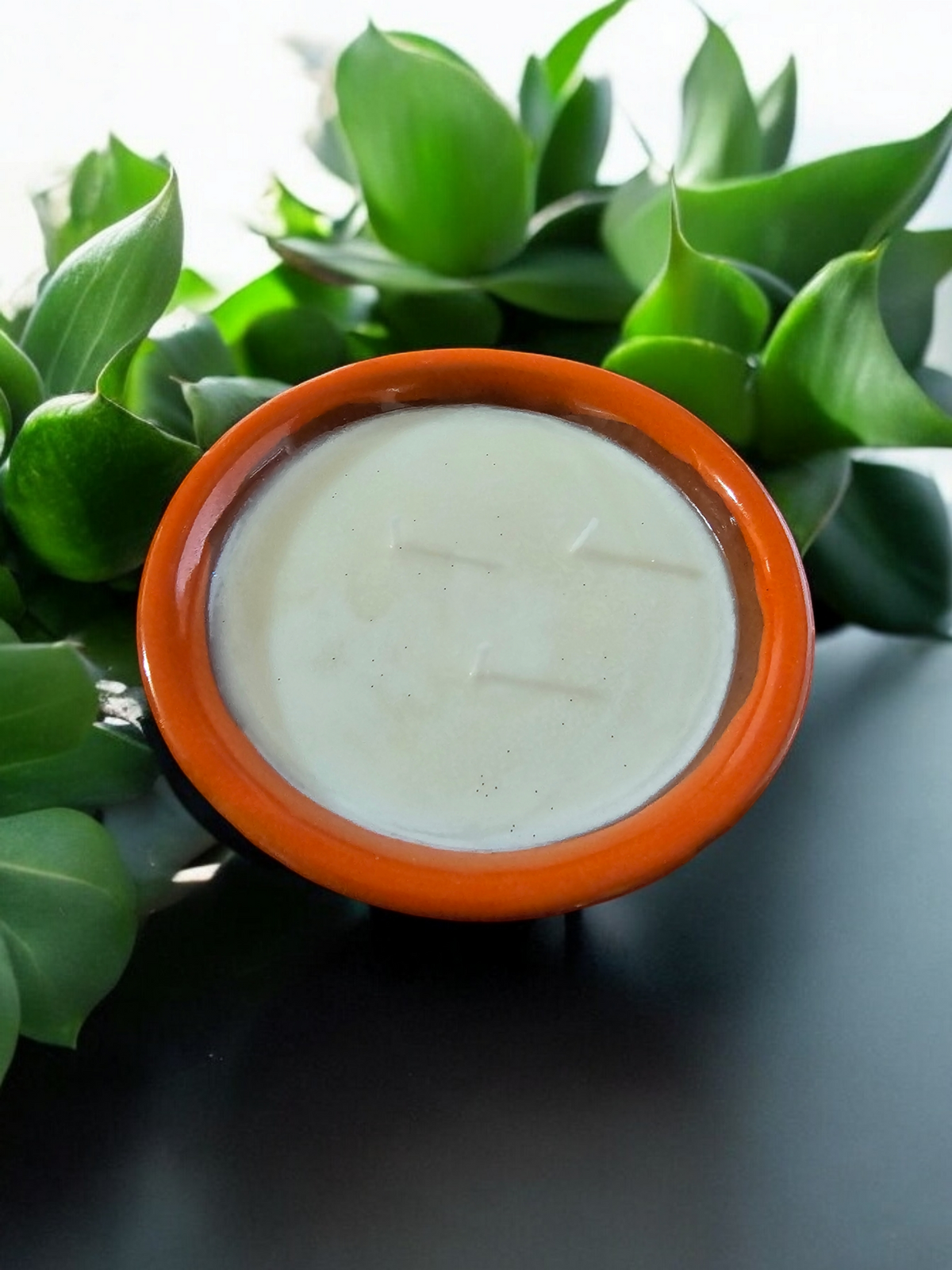 The Vela Lady handmade orange and light brown Mexican lead-free barro salsa bowl soy wax candle with a fresh scent