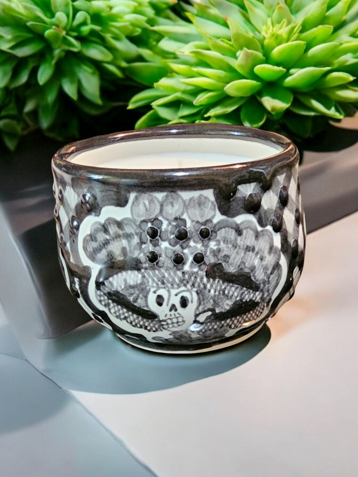 The Vela Lady La Catrina Talavera mug candle featuring hand-painted black and white Mexican Day of the Dead skull art on ceramic