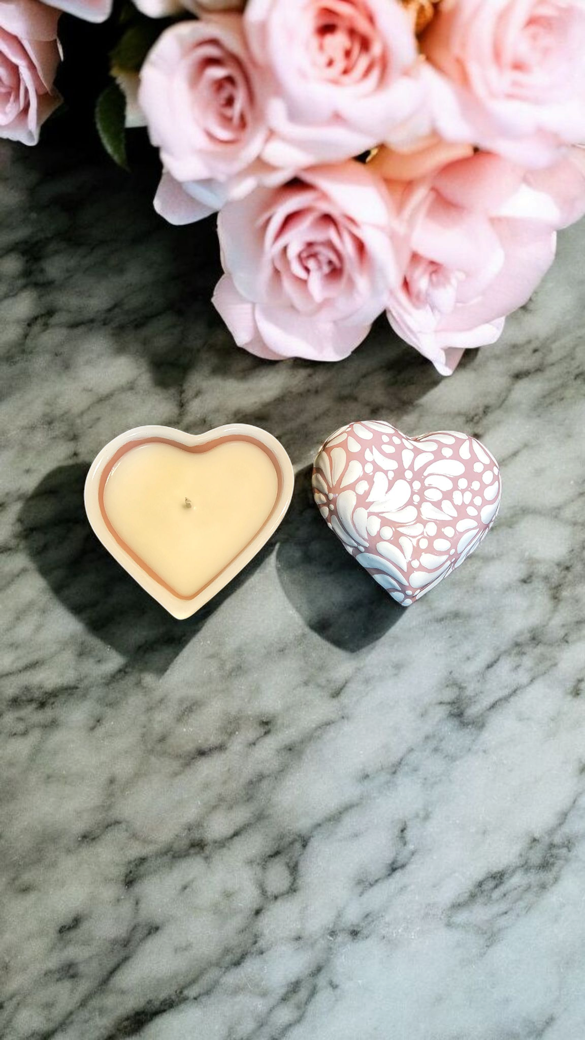 The Vela Lady heart-shaped Talavera candle in white on pink with a soy wax candle and matching ceramic lid.