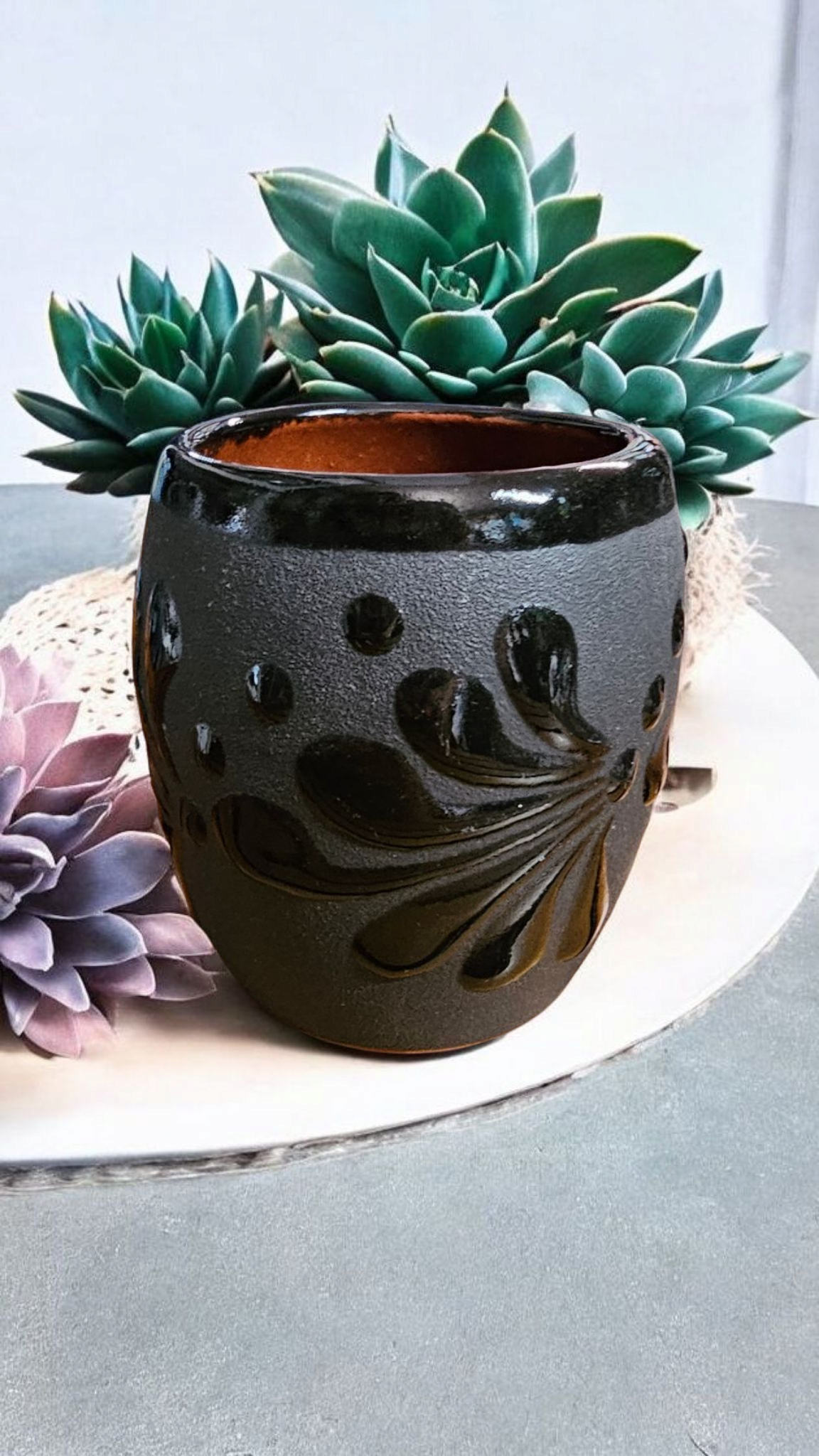 The Vela Lady Papacito Collection black handmade Mexican pottery candle vessel with decorative embossed floral design.
