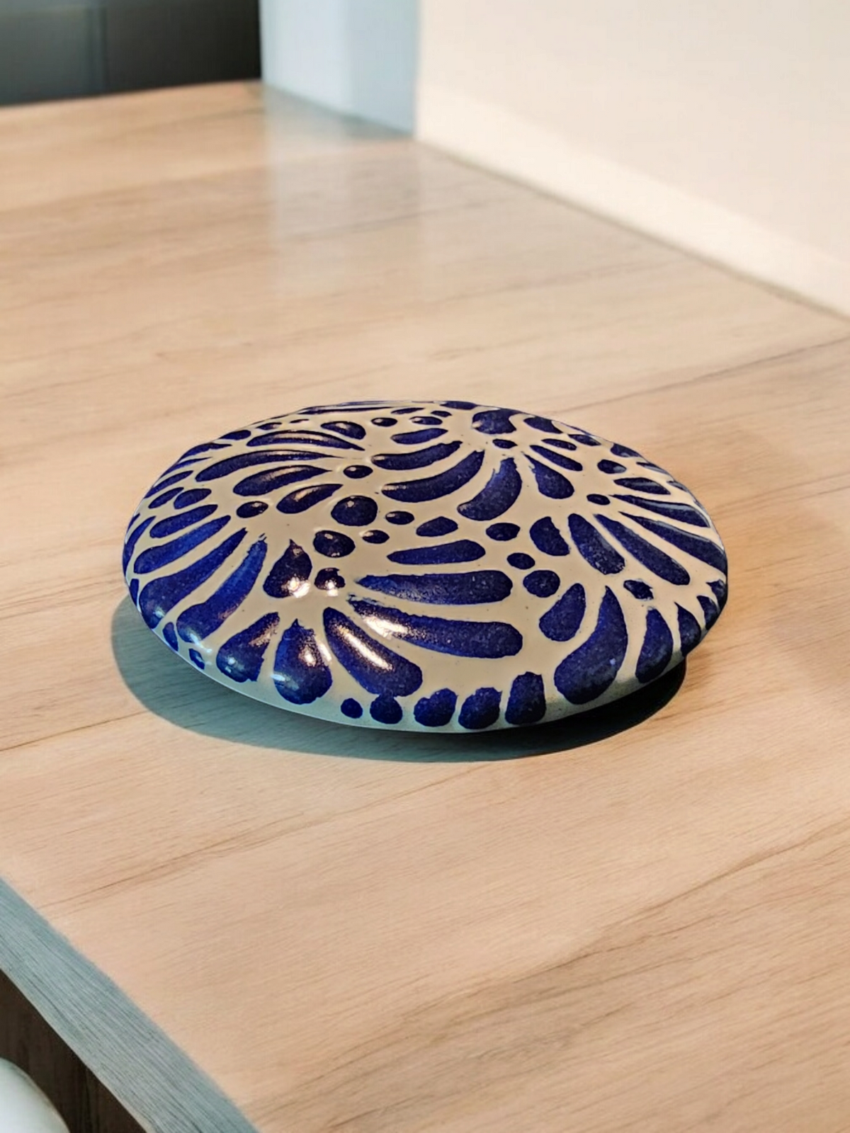 The Vela Lady blue and white Talavera ceramic trinket holder with hand-painted floral patterns on a wooden surface