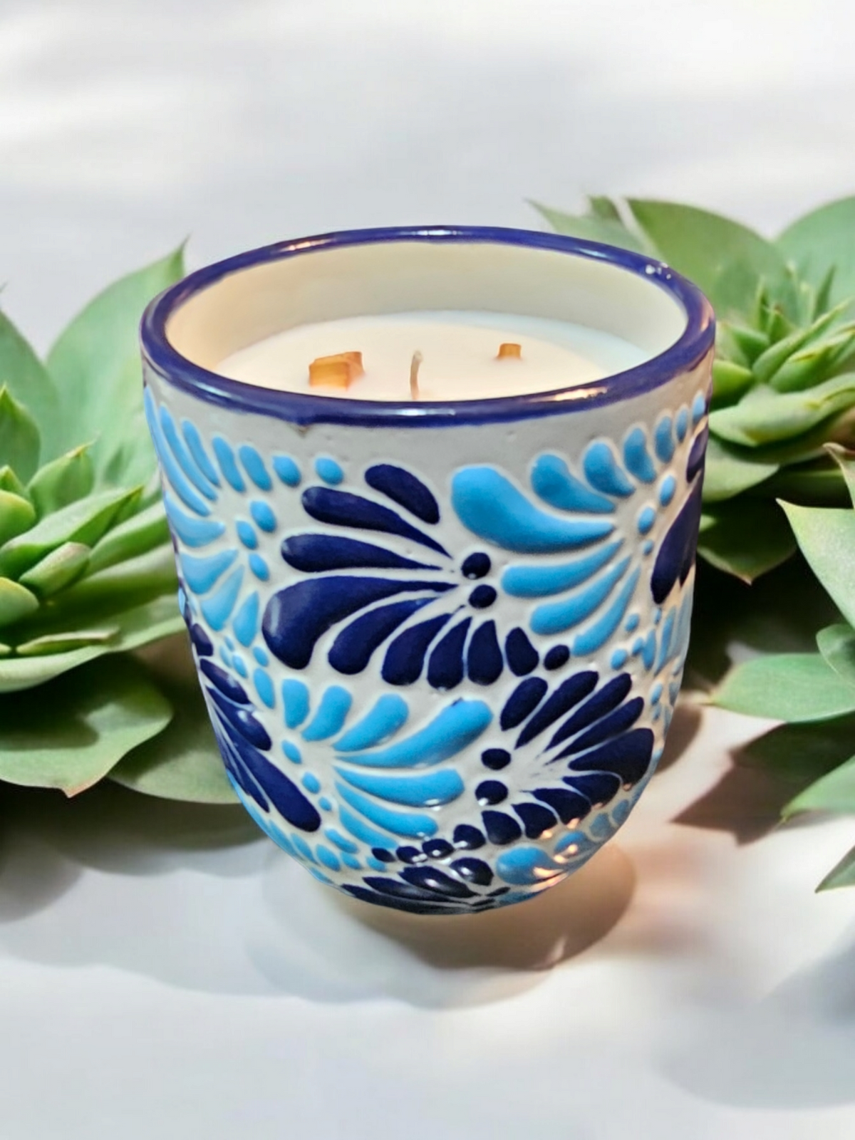 The Vela Lady Buenas Vibras soy wax candle in a hand-painted blue and white Mexican Talavera ceramic tumbler