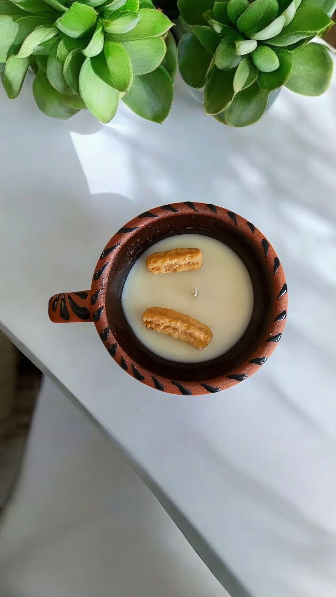 The Vela Lady Taza Collection soy candle in a handmade dark Mexican barro mug with black espiga design and churro wax