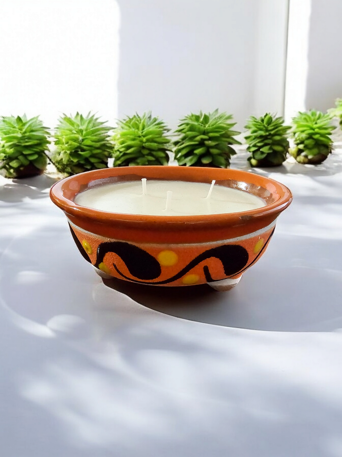 The Vela Lady handmade orange and light brown lead-free Barro pottery salsa bowl candle with premium soy wax and decorative patterns