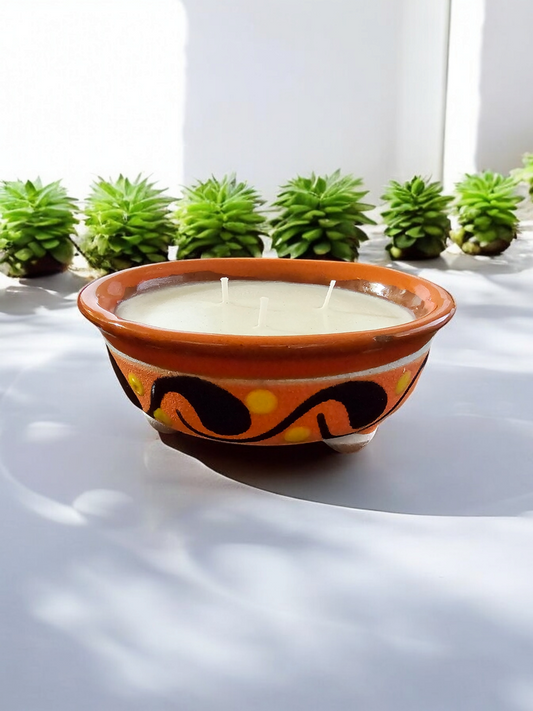 The Vela Lady handmade orange and light brown lead-free Barro pottery salsa bowl candle with premium soy wax and decorative patterns