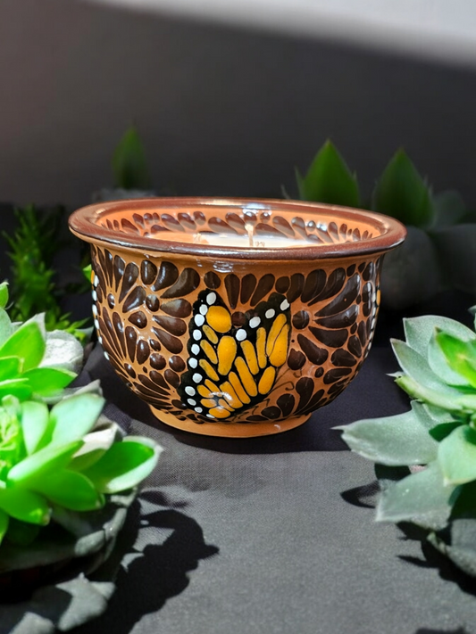 The Vela Lady brown handcrafted Talavera salsa bowl candle featuring a painted butterfly design and soy wax.