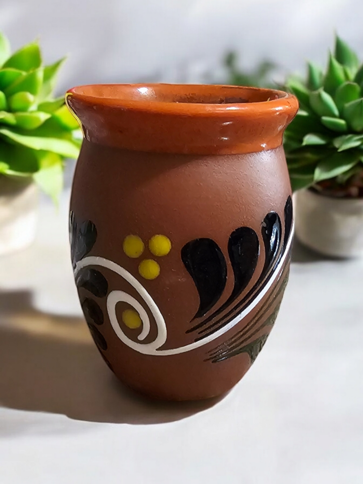 The Vela Lady Loteria Collection El Venado hand-painted Mexican barro cantarito candle vessel with floral motifs.