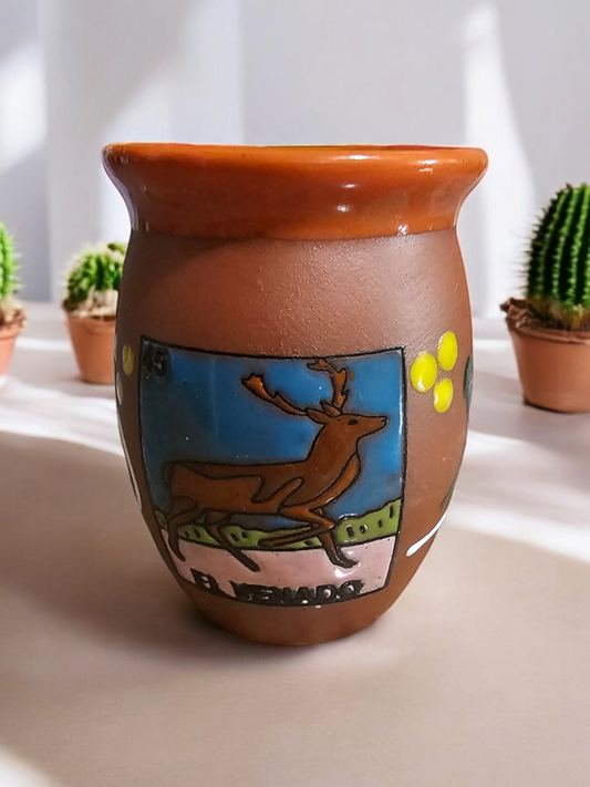 The Vela Lady El Venado Loteria cantarito candle in handmade Mexican barro pottery with hand-painted deer design.