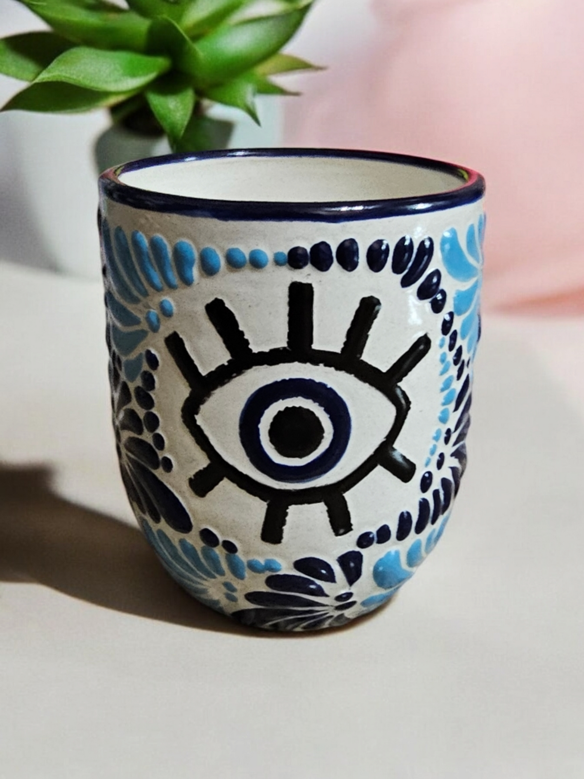 The Vela Lady Buenas Vibras blue and white hand-painted Talavera ceramic tumbler candle with evil eye design