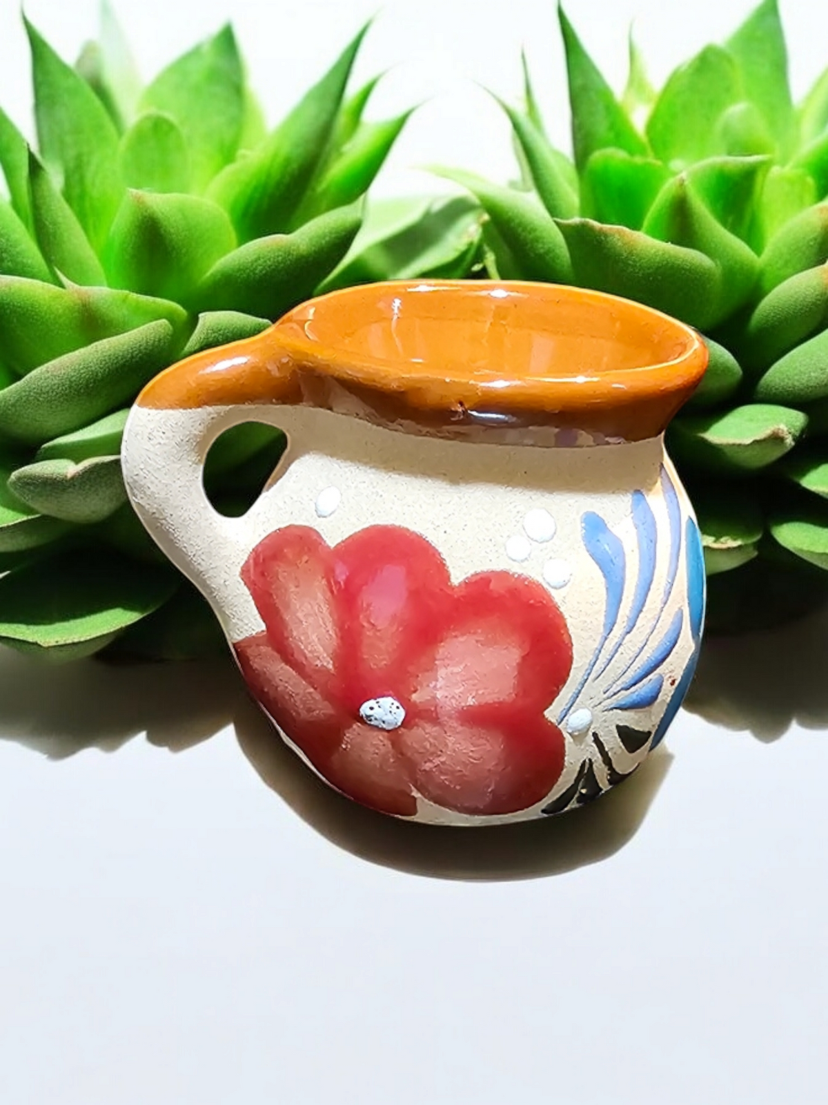 The Vela Lady handmade Mexican lead free barro tazita shot mug candle with hand-painted floral design and soy wax