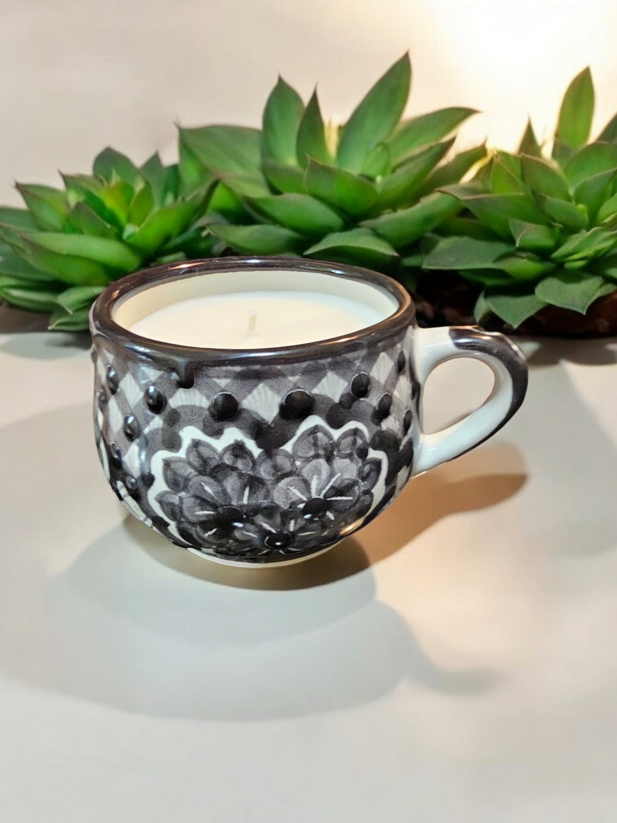 The Vela Lady La Catrina Talavera mug candle with black and white floral hand-painted ceramic design and soy wax