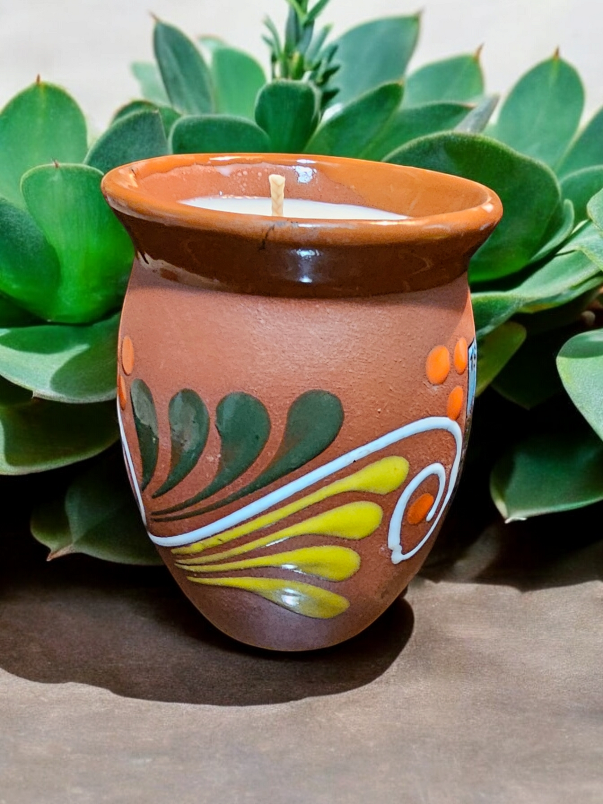 The Vela Lady La Garza Cantarito soy candle in a hand-painted Mexican barro pottery vessel with Paloma scent.