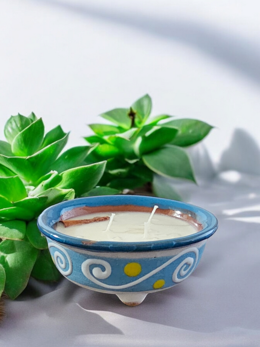 The Vela Lady light blue handmade Mexican lead-free barro salsa bowl with premium soy wax candle with hand-painted swirl designs.  The salsa bowl is reusable after the candle is done.