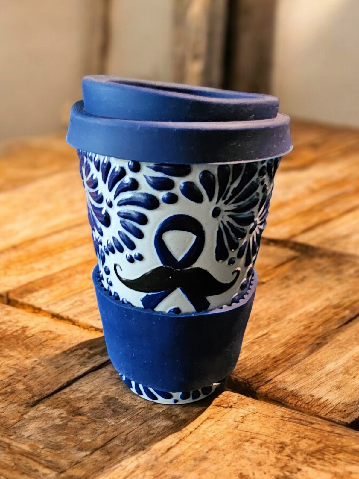 The Vela Lady Men's Health Awareness soy candle in a blue and white hand-painted Mexican Talavera pottery vessel.