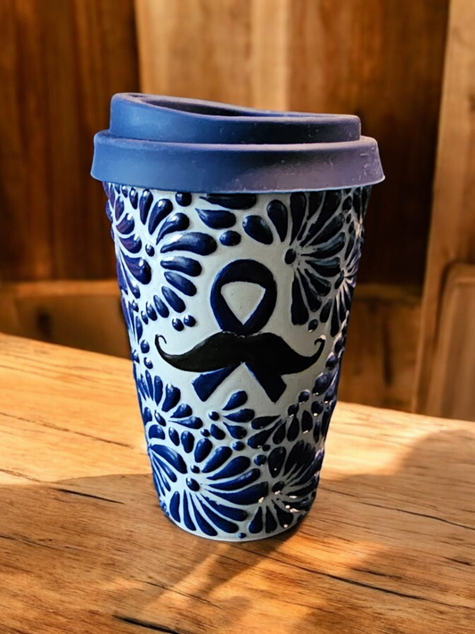 The Vela Lady Men's Health Awareness soy candle in a blue and white hand-painted Mexican Talavera pottery vessel.