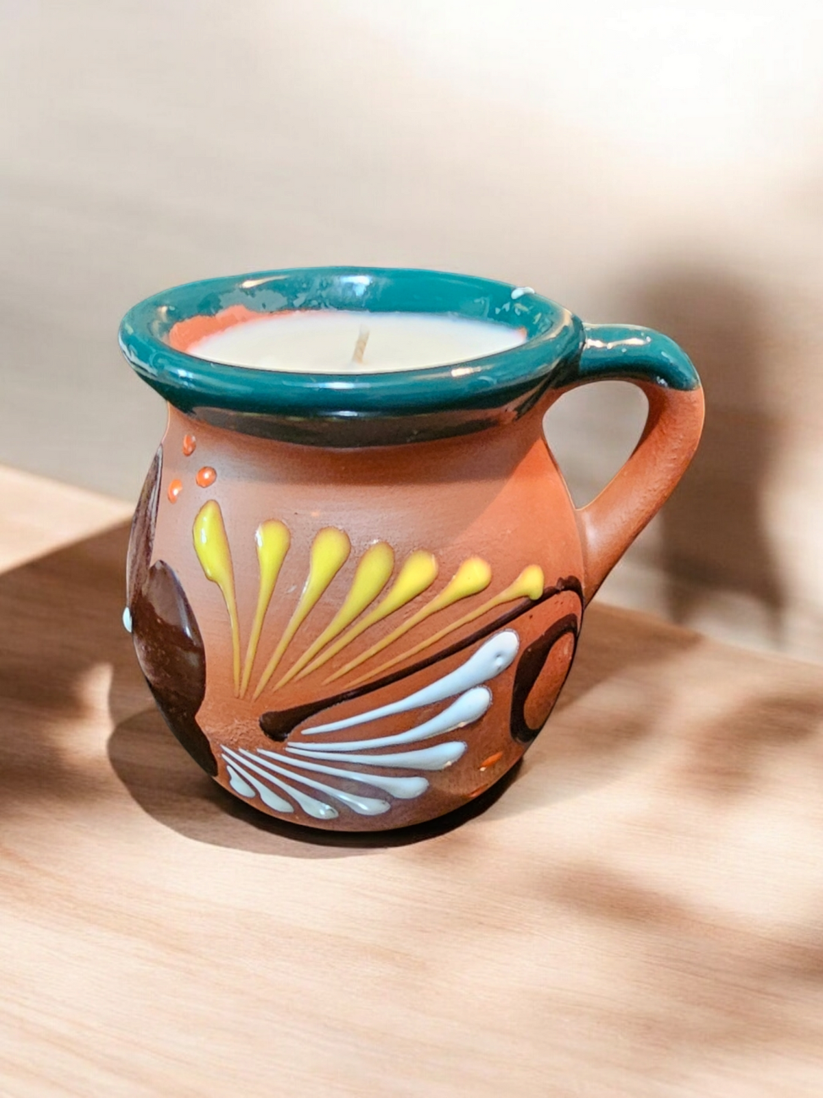 The Vela Lady handmade Mexican barro mug candle with traditional dark floral hand-painted designs and soy wax.