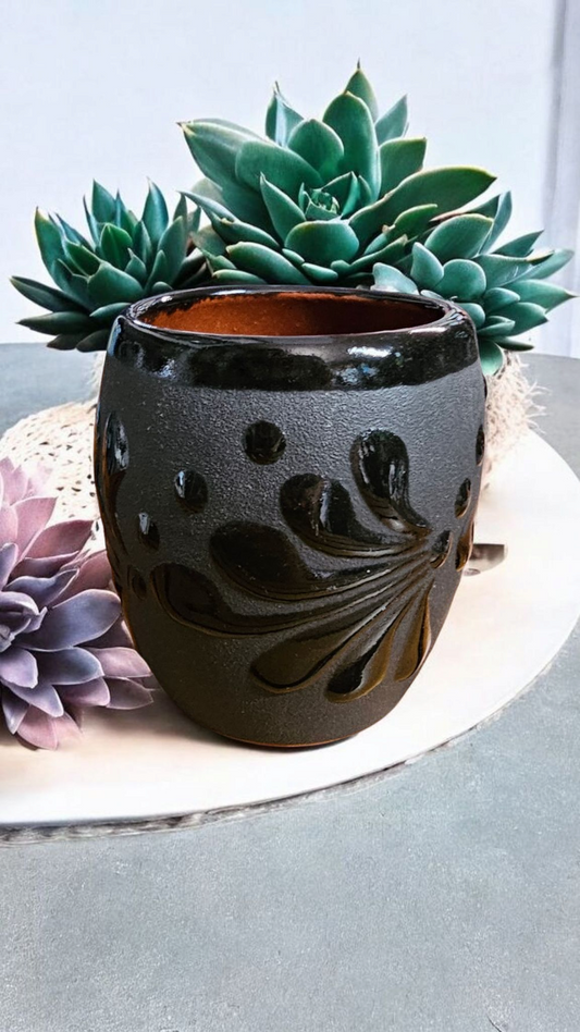The Vela Lady Papacito Collection black handmade Mexican pottery candle vessel with decorative embossed floral design.