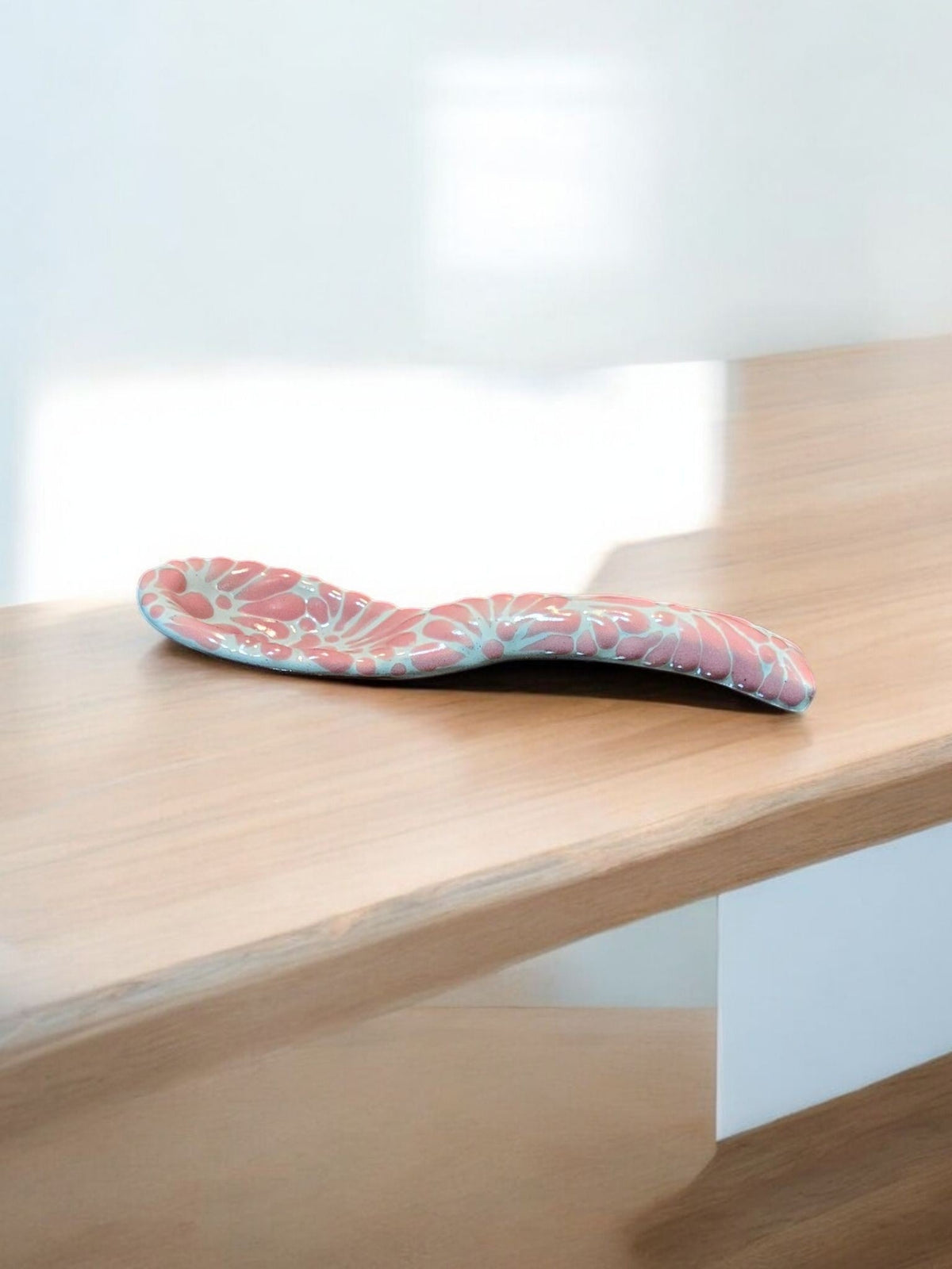 The Vela Lady handcrafted pink and white Talavera salsa bowl with butterfly motifs on a wooden surface.