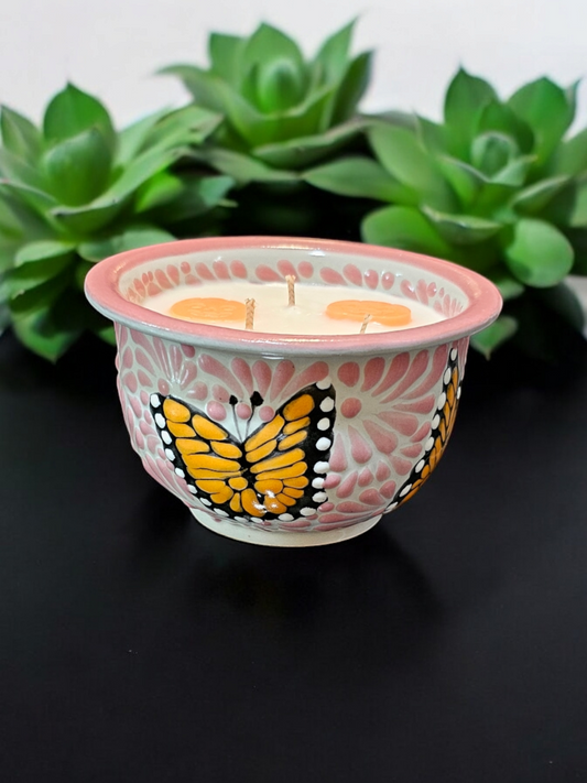 The Vela Lady handcrafted pink and white Talavera salsa bowl candle featuring butterfly designs and soy wax.