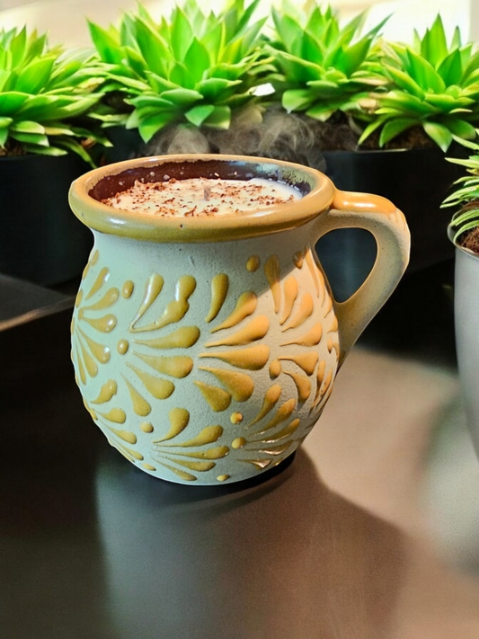 The Vela Lady yellow handmade Mexican barro mug candle with Mangoneada scent and hand-painted floral patterns.